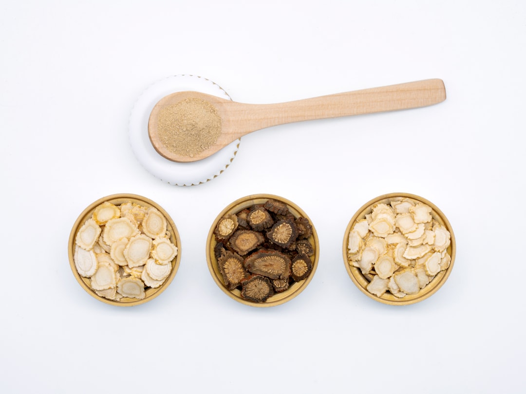Traditional Chinese medicine herbs displayed in ceramic bowls